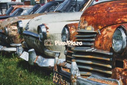 Row of Rusty Vintage Cars in Abandoned Lot